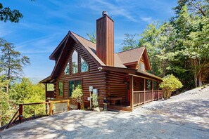 A log cabin with a chimney, large windows, and a porch. - Panoramic Mountain Views, Secluded Cabin, Hot Tub (Sevierville)