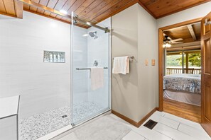 A modern bathroom with a glass shower, white tiles, and a wooden ceiling. - Lakefront Norris Cabin Retreat・Dock・Games・Hot Tub (Sharps Chapel)