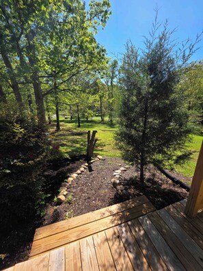 A wooden deck leading to a garden with trees and a lawn. - Tranquil Cabin W Hot Tub・Boat / Motorcycle Parking (Sevierville)
