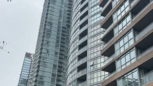 A modern high-rise building with multiple balconies and large windows. - Iceboat Elegance Suites (Toronto)