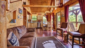 A wooden cabin interior with a living room, kitchen, and dining area. - 8.6 Mi to Dollywood・Serene Cabin Getaway・Hot Tub (Sevierville)