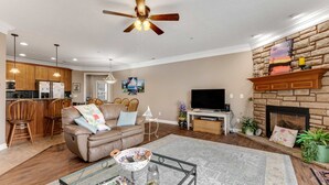 A modern living room with a sofa, coffee table, and fireplace.