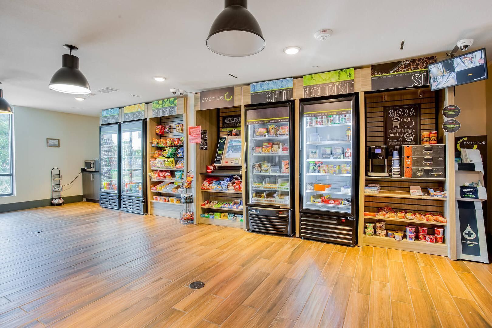 A food kiosk with refrigerated display cases and a variety of snacks and beverages.