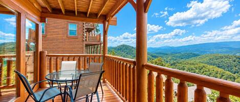 Panoramic Smoky Mountain views from the covered deck at A Walk in the Clouds, a cabin at Black Bear Ridge Resort in Pigeon Forge, Tennessee.