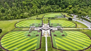 A large, symmetrical sports complex with multiple fields and a central building.