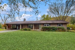 A single-story brick house with a front porch, a chimney, and a well-maintained lawn. - 5 Mi to GSMN・Serene Dog Ok・Cosby Stay, Sleeps 7 (Cosby)