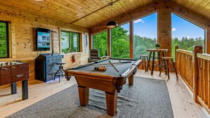 A wooden interior with a pool table, foosball table, and bar area. - The Treehouse, Sleep 12・Hot Tub・Firepit・Game Room (Sevierville)