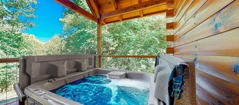 Wooded cabin w/ hot tub, fireplaces, & furnished deck