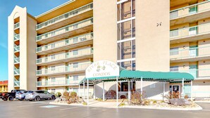 A multi-story building with a sign for 'River Place Condos'. - Cozy Riverfront Downtown Condo, Sleeps 6, Balcony (Pigeon Forge)