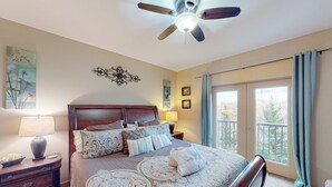 A bedroom with a bed, nightstands, a ceiling fan, a window with curtains, and artwork on the walls. - 2.4 Mi. to DT Pigeon Forge Stay・Hot Tub・Grill・Pool (Pigeon Forge)