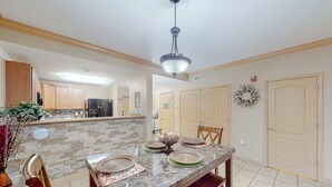 A spacious kitchen with a marble countertop, wooden cabinets, and a central island. - 2.4 Mi. to DT Pigeon Forge Stay・Hot Tub・Grill・Pool (Pigeon Forge)