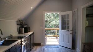 A kitchen with a built-in oven and a large window. - Norah's Nest 
"Step into your own private retreat!" (WOODSTOCK)