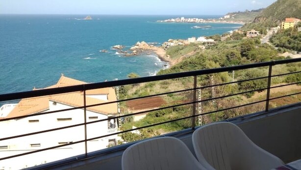 A balcony with a view of the sea and coastal buildings. - Vacation rentals in Bejaia (Béjaïa)