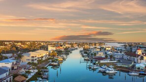 A marina with boats docked, surrounded by residential buildings and a calm waterway. -  2BR/2BA Madeira Beach Condo, Beach access, Heated Pool, Near John’s Pass. (Madeira Beach)