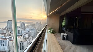 A modern interior with a large window overlooking a cityscape at sunset. - SHB - High Standard with Panoramic View! (Santos)