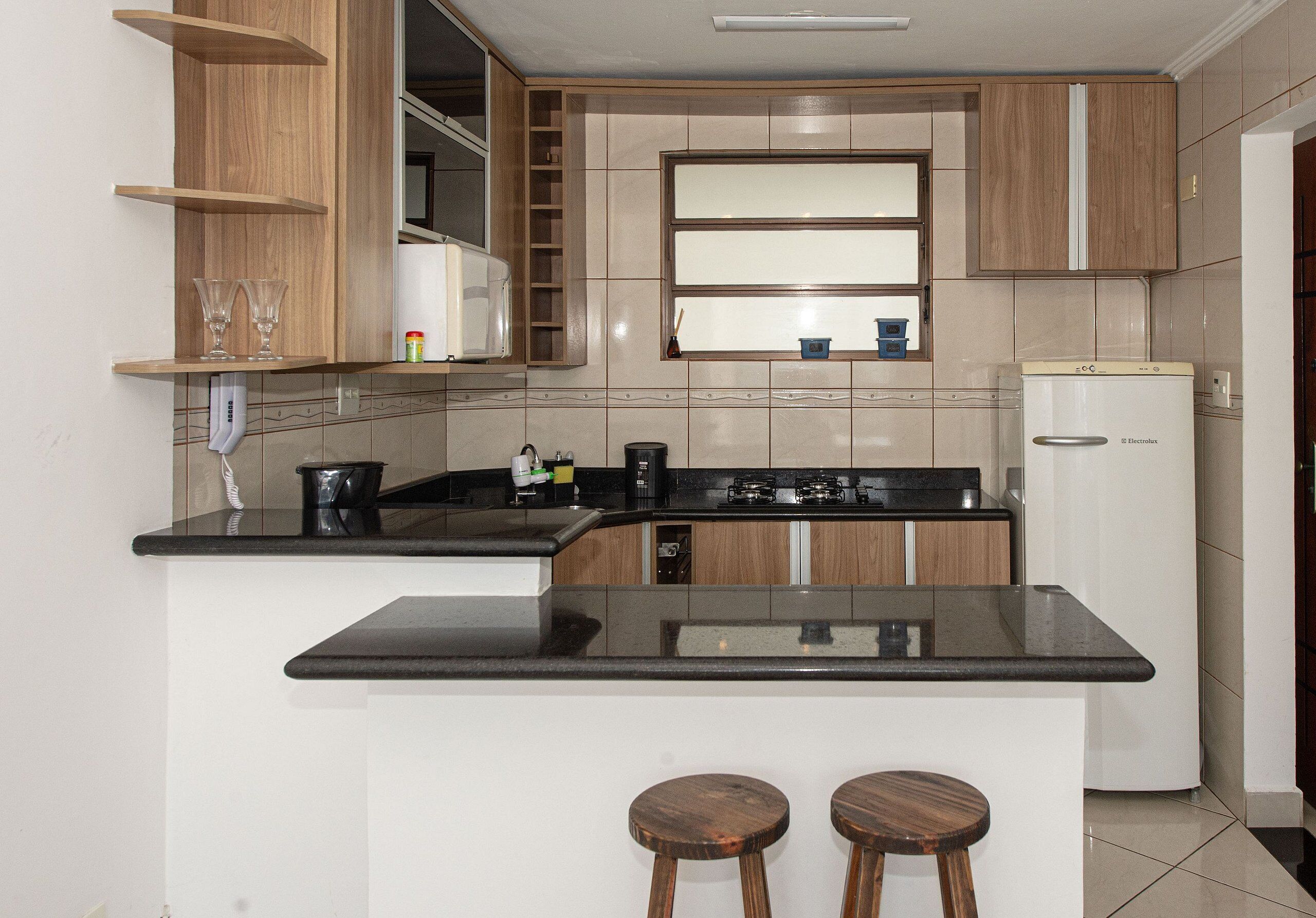 Fridge, microwave, coffee/tea maker, cookware/dishes/utensils