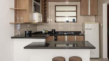 Fridge, microwave, coffee/tea maker, cookware/dishes/utensils