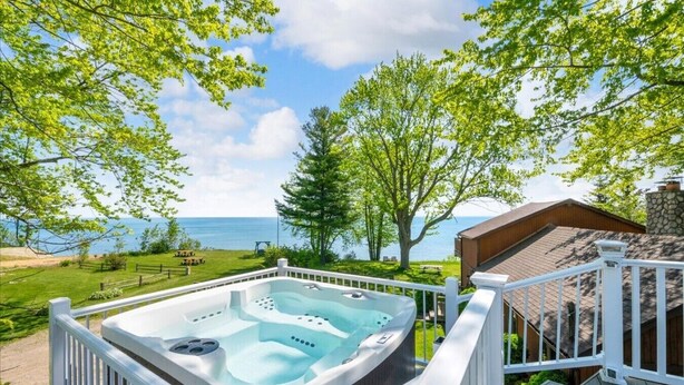 A hot tub on a deck with a view of the ocean. - The Lakeview Lookout - Gorgeous Lake Views! (Lexington)