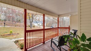 A covered porch with a red railing, a rocking chair, and a potted plant. - Hike & Sip in North Georgia: Apartment w/ Deck (Alto)