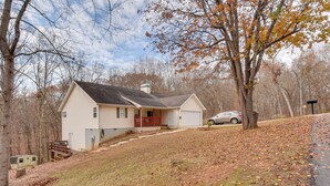 A single-story house with a front porch, a garage, and a small deck. - Hike & Sip in North Georgia: Apartment w/ Deck (Alto)
