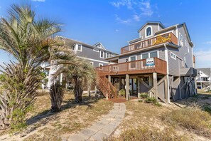 A two-story building with a wooden deck and a balcony. - Ocean Views! New 4bd Home, very close to Beach! (Oak Island)