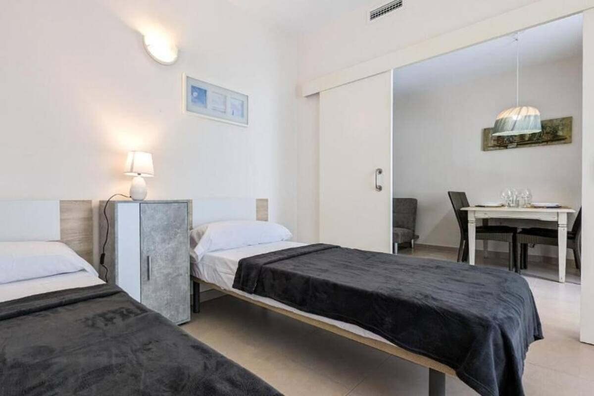 Une chambre d’hôtel avec deux lits, un bureau et une chaise.