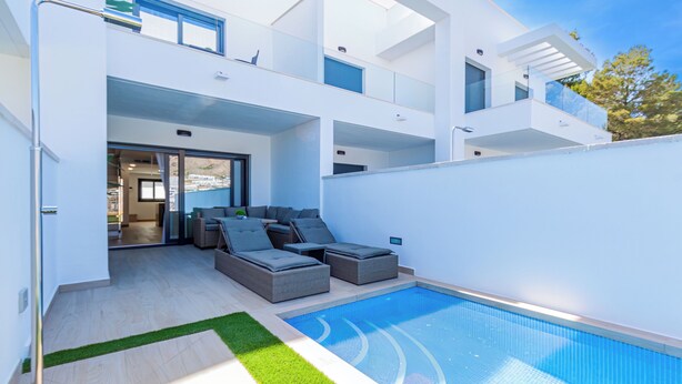 A modern two-story house with a swimming pool, outdoor seating, and a view of the surrounding area. - Panoramic Apartments (Finestrat)