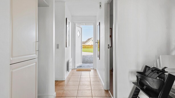 A hallway with white walls, a tiled floor, and doors leading to other rooms. - Amazing home in Brenderup Fyn with sauna (Brenderup Fyn)