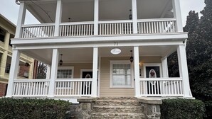 A two-story building with a balcony, a stone staircase, and a sign reading "The Cherrydale."