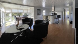 A modern interior with a dining area, kitchen, and open space.