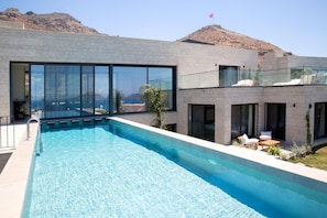 A modern pool area with a clear view of the mountains in the background. - VistaPort A (Bodrum)