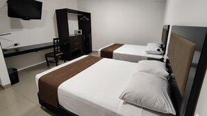 A hotel room with two beds, a desk, a chair, a TV, and a wardrobe. - Hotel Win & Win (Piura)