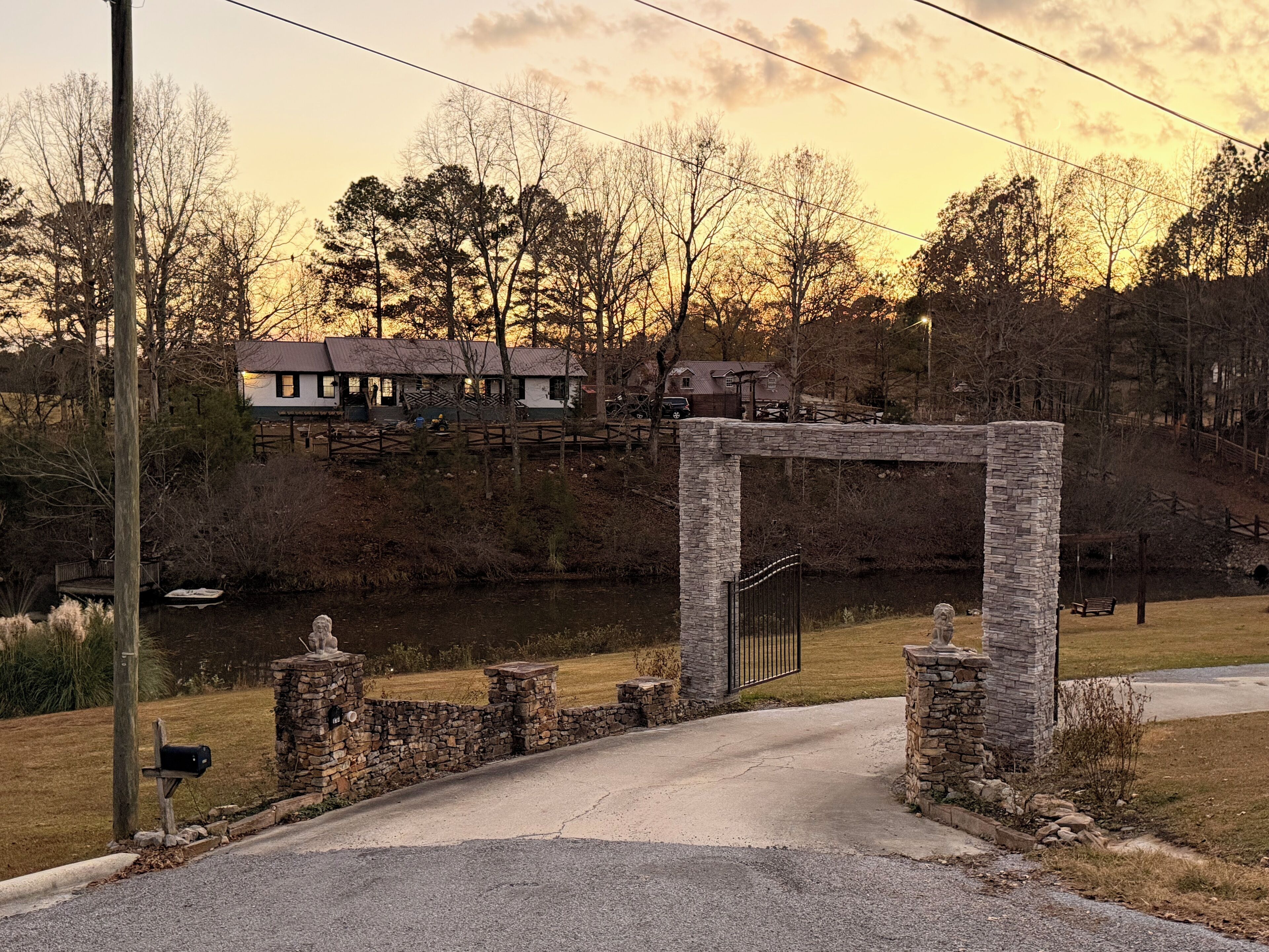 Gated long driveway that leads to the house, with stunning views of the lake.
