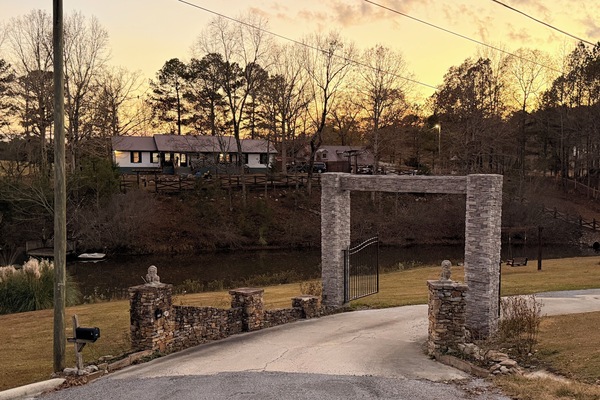 Gated long driveway that leads to the house, with stunning views of the lake.