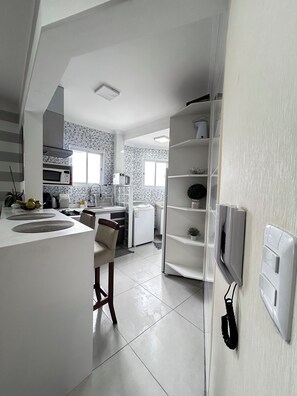 Fridge, microwave, oven, stovetop - Modern apartment in Praia Grande, 500m from the beach, with air conditioning, garage, and Wi-Fi. (Praia Grande)