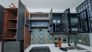A modern kitchen with wooden cabinets, a microwave, a coffee maker, and a sink. - Your home with Comfort, Security and BBQ in El Poblado, Medellin! Super location (Medellín)