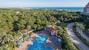 A resort with a swimming pool, lounge chairs, and a view of the ocean. - 1BR oceanview studio with private balcony (Miramar Beach)