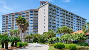 A multi-story hotel with balconies, palm trees, and a clear sky. - Luxury condo w/private balcony & resort access (Miramar Beach)