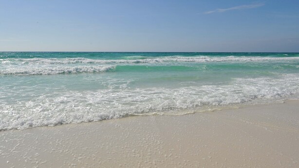 A beach with clear turquoise water and white sand. - Luxury condo w/private balcony & resort access (Miramar Beach)