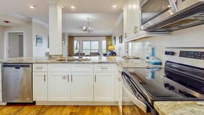 A modern kitchen with a dishwasher, oven, and microwave. - Exclusive Gulf Views: 2BR Beachfront Oasis (Miramar Beach)