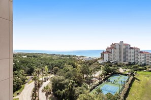 A hotel with multiple floors, a tennis court, and a view of the sea. - Gulf Views & Resort Access, Beach Steps Away (Miramar Beach)
