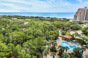Ein Resort mit Pool, Palmen und Meerblick.