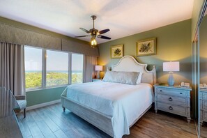 A bedroom with a bed, nightstands, a ceiling fan, and large windows. - Exclusive 3BR condo with Gulf views (Miramar Beach)