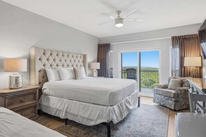 A hotel room with a large bed, a desk, a chair, and a balcony with a view. - Exclusive beachfront studio for 2 (Miramar Beach)