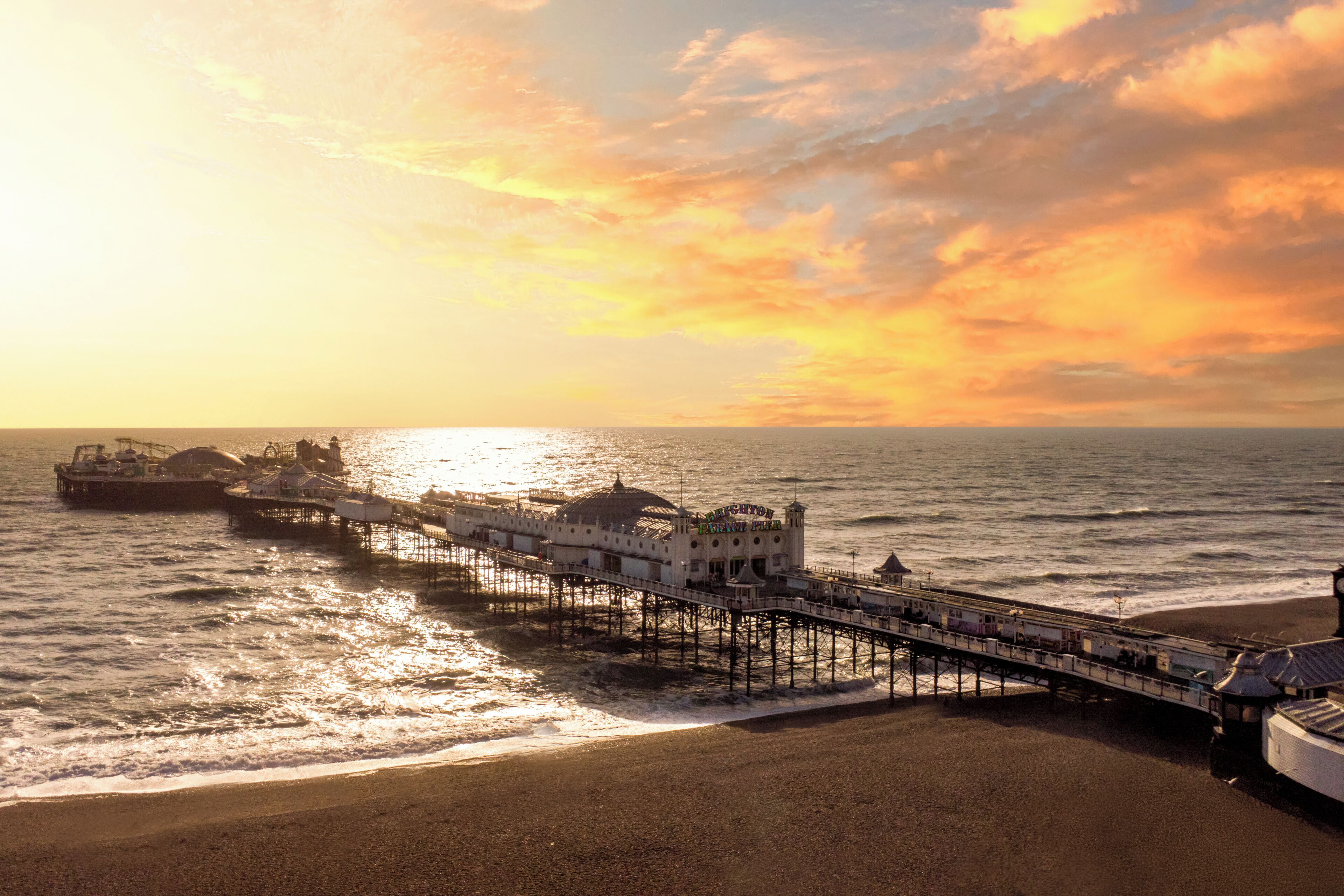 A pier extending into the sea with a building at the end.