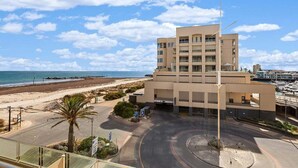 Ein modernes Gebäude mit Parkplatz und Blick auf den Strand.