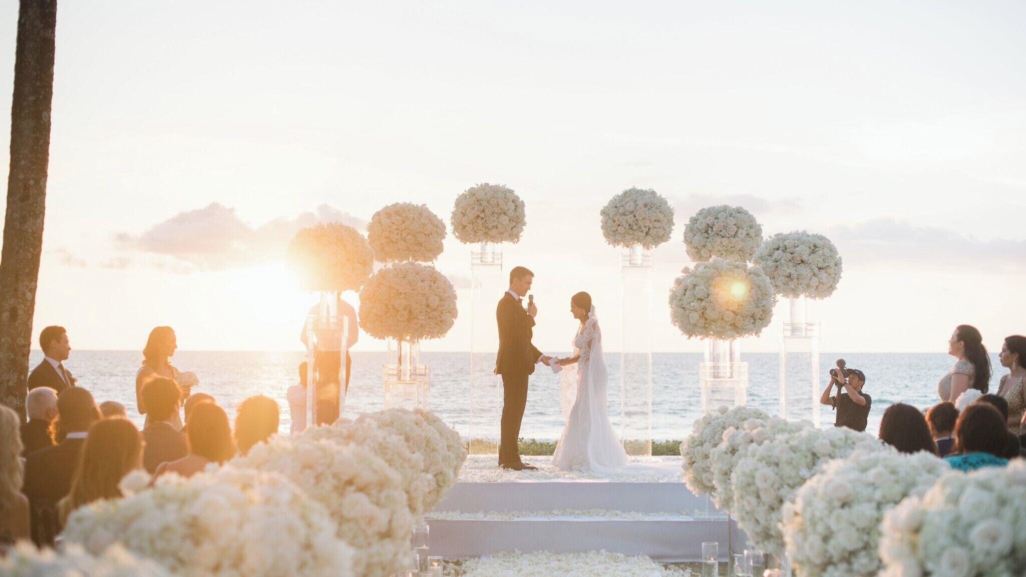 A wedding ceremony at a beachfront venue with a clear view of the ocean.