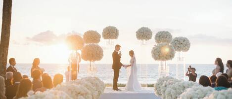 A wedding ceremony at a beachfront venue with a clear view of the ocean.