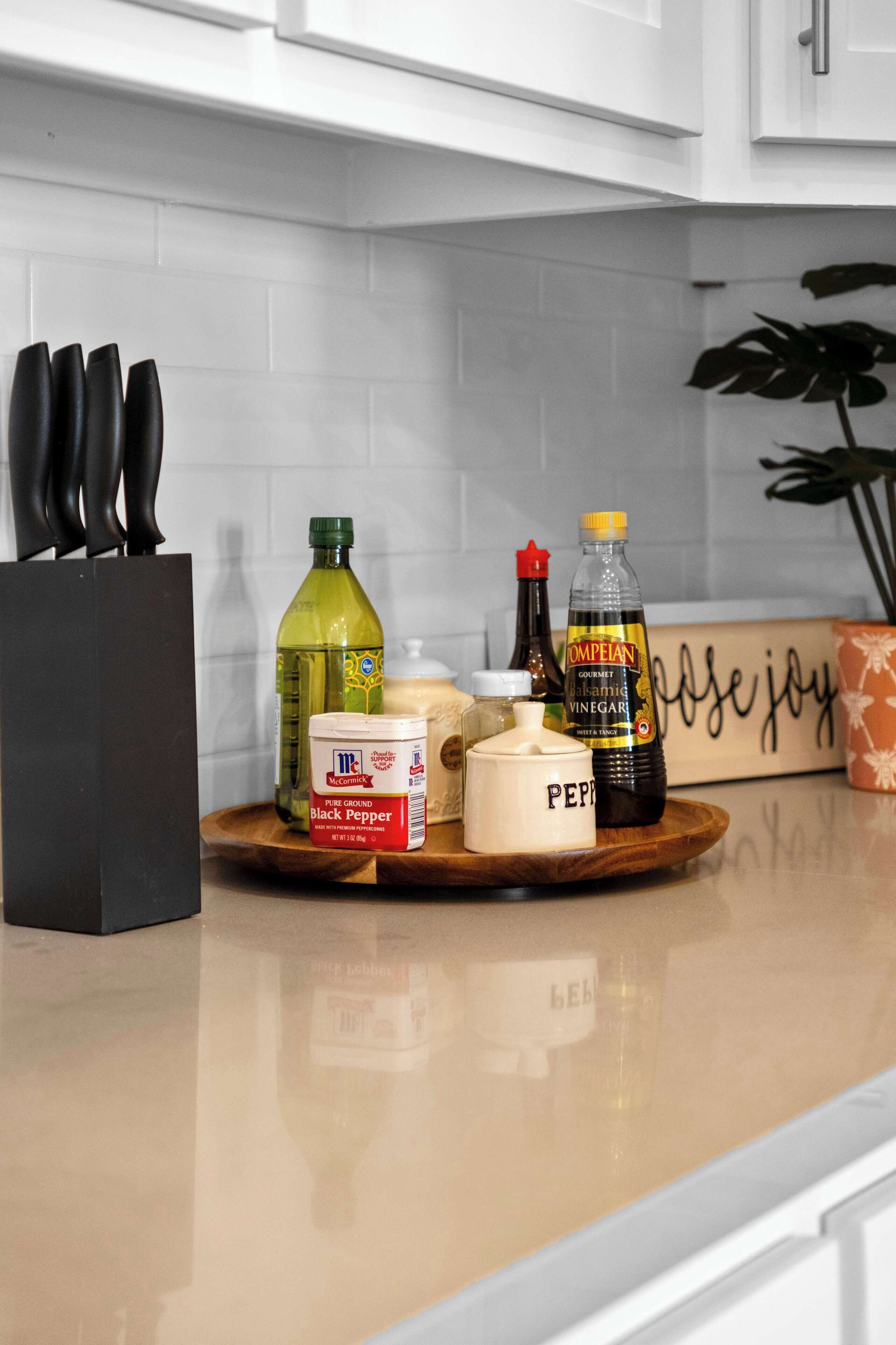 Un plan de travail de cuisine avec divers condiments et un bloc à couteaux.