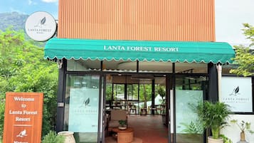 The entrance of Lanta Forest Resort with a welcoming sign, a covered entrance, and a view into the interior.